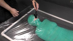 Mummification bandage, vibrator and inflatable gag in a vacuum bed