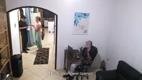 While the Husband Works, the Wife in a Towel Greets the Delivery Man