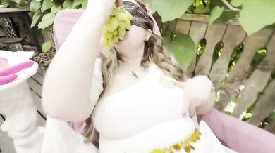 The Goddess is eating grapes and showing her tits on the terrace
