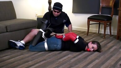 Brunette in jeans and boots bound and gagged during intense BDSM session