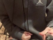 A guy in a gray sweater on a chair cums with a waterfall