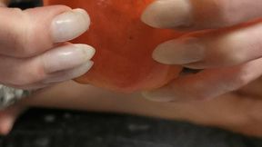 Pointy natural nails clawing apple