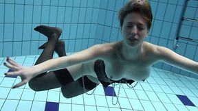 Hot pale skin gingerhead girl in stockings underwater