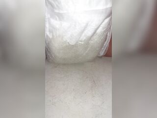 Playgirl fills up diaper with piddle until it overflows out the side