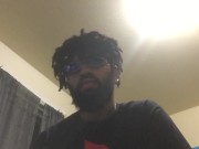 Young male sits and  stares at you
