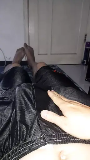 Pleasure wearing shiny slippery black shorts bulge