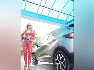 At the car washing station in red vinyl outfit