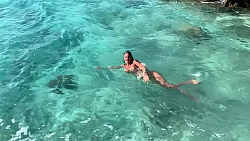 Naked beauty Monika Fox swims solo in the sea
