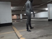 wetsuited & masked in parking garage