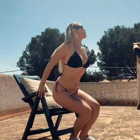 Kinky girl wearing glasses sunbathing and masturbating!