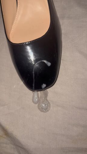 Cumming on black patent heels