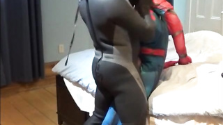 wetsuited crazy boy plays with his spiderman fool