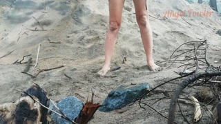 Public peeing teen girl on the beach