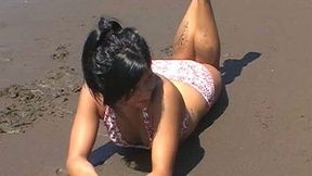 Gorgeous tight tiny brunette girl on the beach flashing