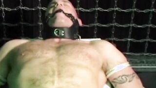 Submissive young man moans as he is gagged and tied up