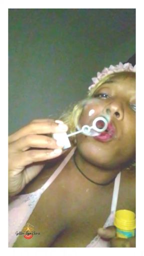 Ebony Goddess blowing bubbles