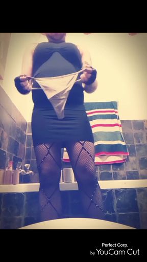 Slim blonde adult woman pisses in thong while crossdressing solo