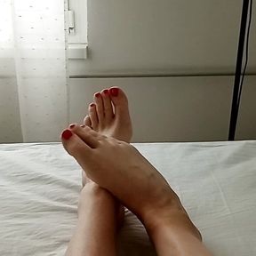 Milf tranny shows off her beautiful smooth legs and feet with red painted toes