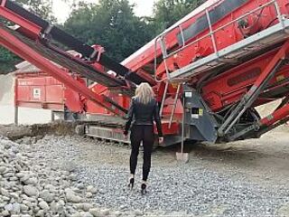 Granny is walking around in a gravel pit wearing sheer leggings!