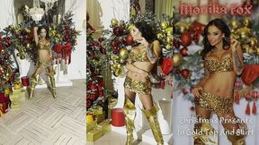 monika fox christmas presents in gold top and skirt