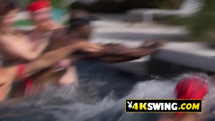 Partner exchange at a pool party kissing contest between hot swinger couples.
