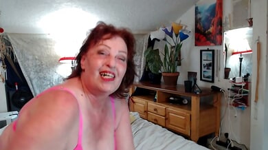 Mature curvy redhead enjoys a solo bedroom session in soft light