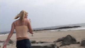”Petite teen masturbating on the beach”
