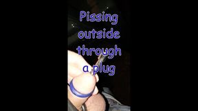 Pissing through a penis plug