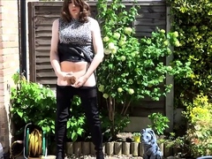 Sexy masturbating crossdresser in thigh boots outdoors