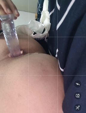 The cute crossdresser plays with her anus with a crystal dildo