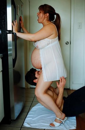 Pregnant woman leaning on refrigerator