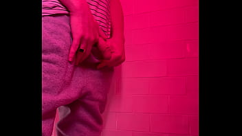 Guy pissing in the toilets of a bar