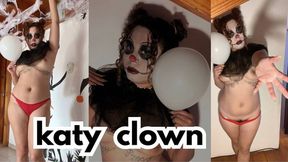The clown Katy sucks a dildo with lots of saliva