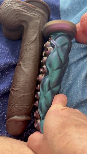 The latex titty slut pushes three monstrous dildos in a row!