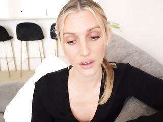 Passionate golden-haired is wearing white stockings and sexy lingerie during a JOI session in her bedroom