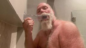 DaddybearAZ deep throats a dildo in the shower