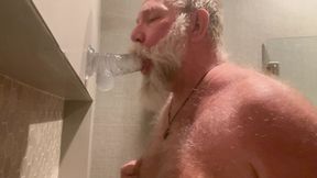 DaddybearAZ deep throats a dildo in the shower