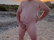 Naked on the beach wanking and cuming on the rock
