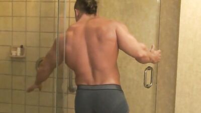 Well-shaped gym buddies are making out and touching one another