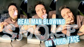 Giant straight man blowing smoke on your face