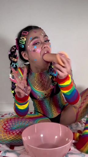 Colorful clown eating hot dog