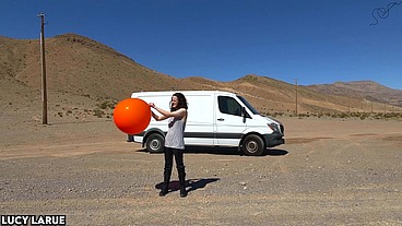 "Vanlifer Pops A Giant Orange Balloon in the Desert"