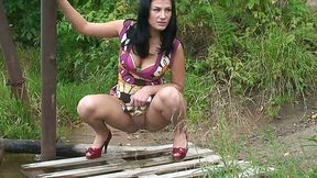 Busty charming black head exposes thighs as she pees outdoors