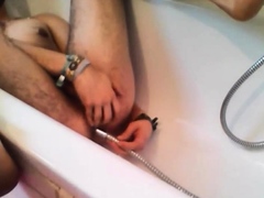 Bi-guy using shower head, squirting water, enema