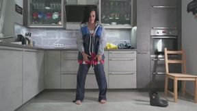 Amira in layers of rainwear and bondage