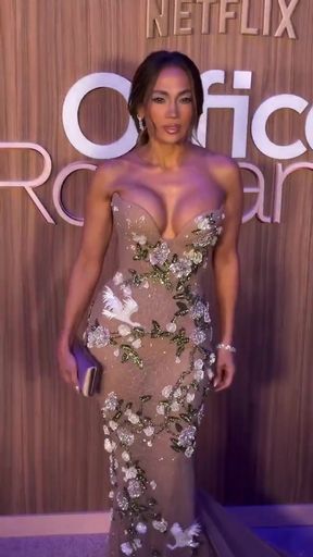 Crossdresser with great cleavage gets dressed by Jennifer Lopez