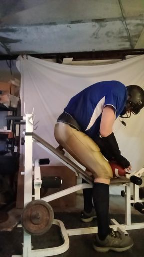 Football jock stretching himself