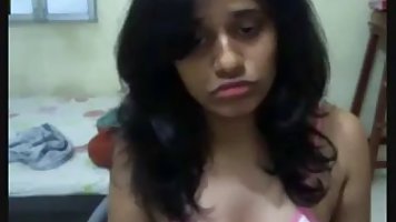 Dark haired, Indian girl is making her first web cam video, because she needs some money