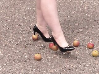 Crush fetish outdoors Corpulent legs in high heel shoes crush apples