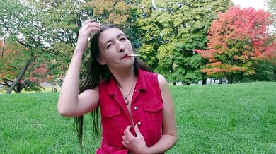 Gypsy Dolores bares it all in a red shirt while smoking in an autumn park